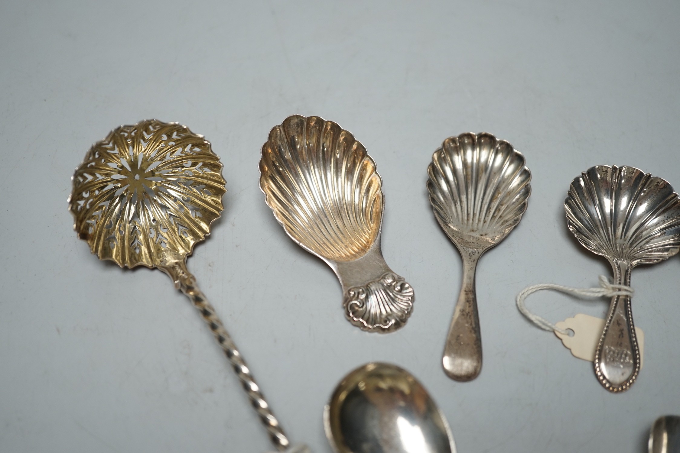 Three assorted 19th century silver caddy spoons, including London, 1829, three 20th century silver caddy spoons and two other silver spoons including Victorian sifter spoon, 14.7cm.